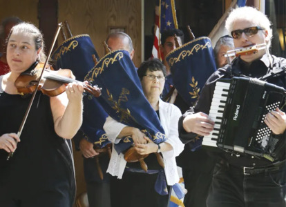 All the local Jewish congregations helped carry the Torahs from their former Noyes Street location to their new home on the TBE campus. Pictured (center) are Rabbi Braun of TBE and (right) Rabbi Sruli Dresdner of Temple Shalom in Auburn.